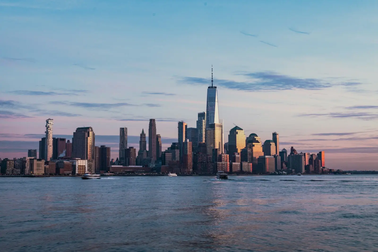 A city skyline across the water at golden hour